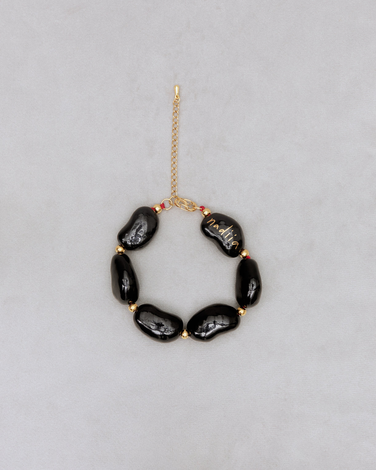 Купіть виріб ручної роботи Black "Beans" Bracelet від Nadiia World. Ідеальний вибір для додавання вишуканості та шарму до вашого житлового простору або колекції особистих аксесуарів.