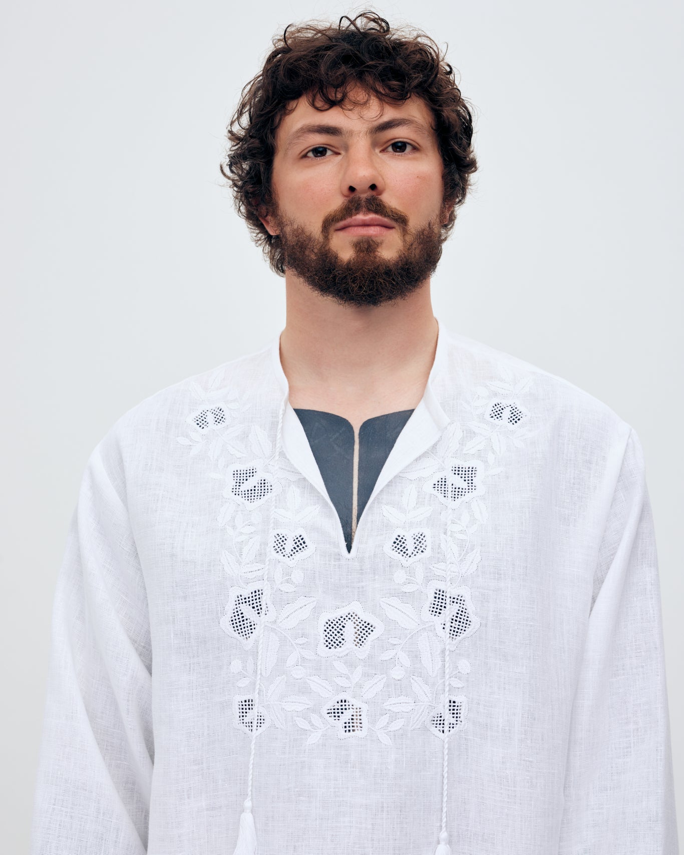 Купіть виріб ручної роботи Embroidered shirt Babylon XX in White від Nadiia World. Ідеальний вибір для додавання вишуканості та шарму до вашого житлового простору або колекції особистих аксесуарів.