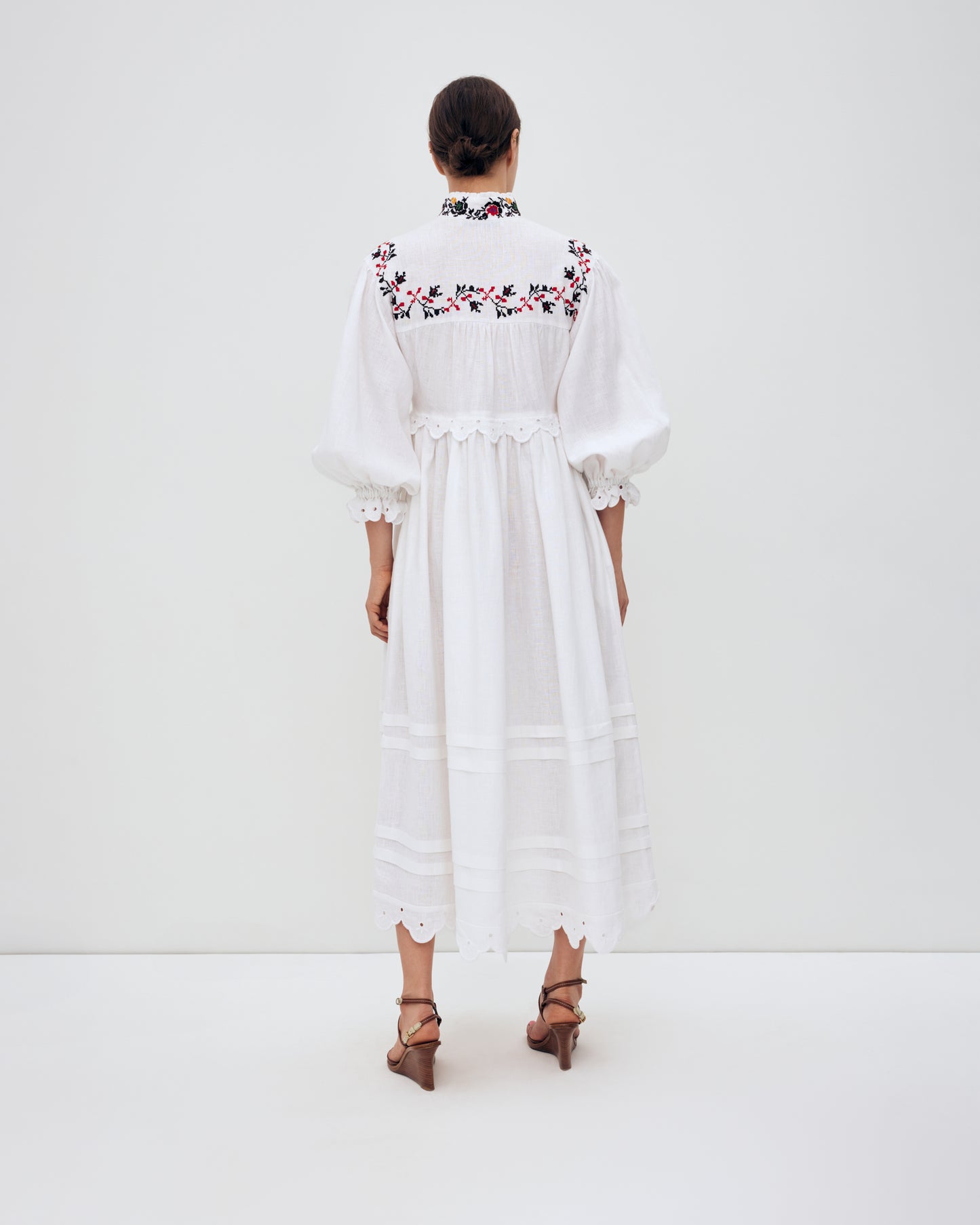 Купіть виріб ручної роботи Long embroidered dress with a high neck "Korolivna" від Nadiia World. Ідеальний вибір для додавання вишуканості та шарму до вашого житлового простору або колекції особистих аксесуарів.