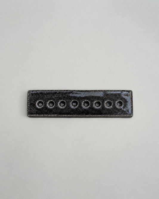 An Eight-Arm Candle Holder in Black