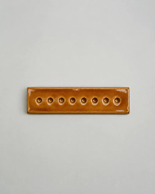 An Eight-Arm Candle Holder in Amber
