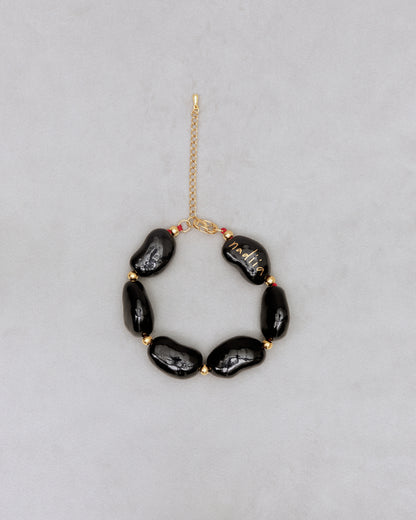 Купіть виріб ручної роботи Black "Beans" Bracelet від Nadiia World. Ідеальний вибір для додавання вишуканості та шарму до вашого житлового простору або колекції особистих аксесуарів.