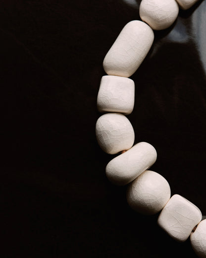 Купіть виріб ручної роботи Necklace with white ceramic beads від Nadiia World. Ідеальний вибір для додавання вишуканості та шарму до вашого житлового простору або колекції особистих аксесуарів.