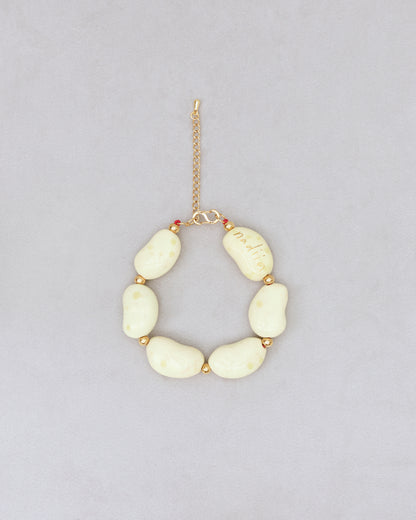 Купіть виріб ручної роботи Yellow Speckled "Beans" Bracelet від Nadiia World. Ідеальний вибір для додавання вишуканості та шарму до вашого житлового простору або колекції особистих аксесуарів.