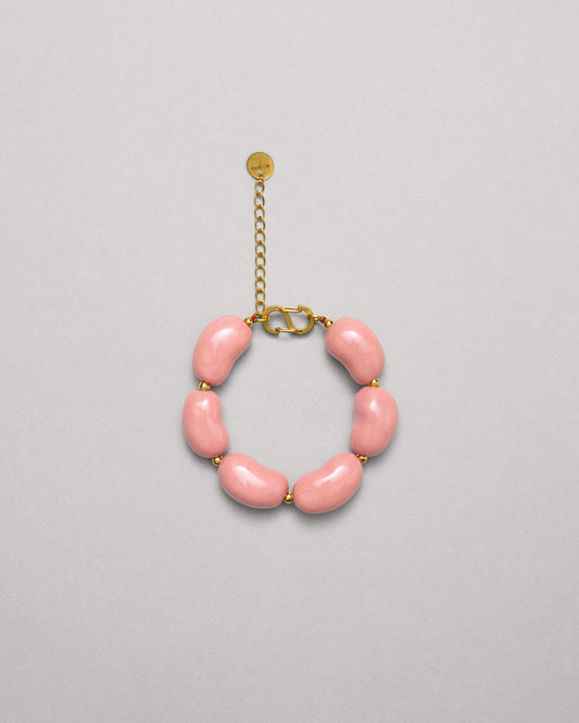 Купіть виріб ручної роботи Pink "Beans" Bracelet від Nadiia World. Ідеальний вибір для додавання вишуканості та шарму до вашого житлового простору або колекції особистих аксесуарів.